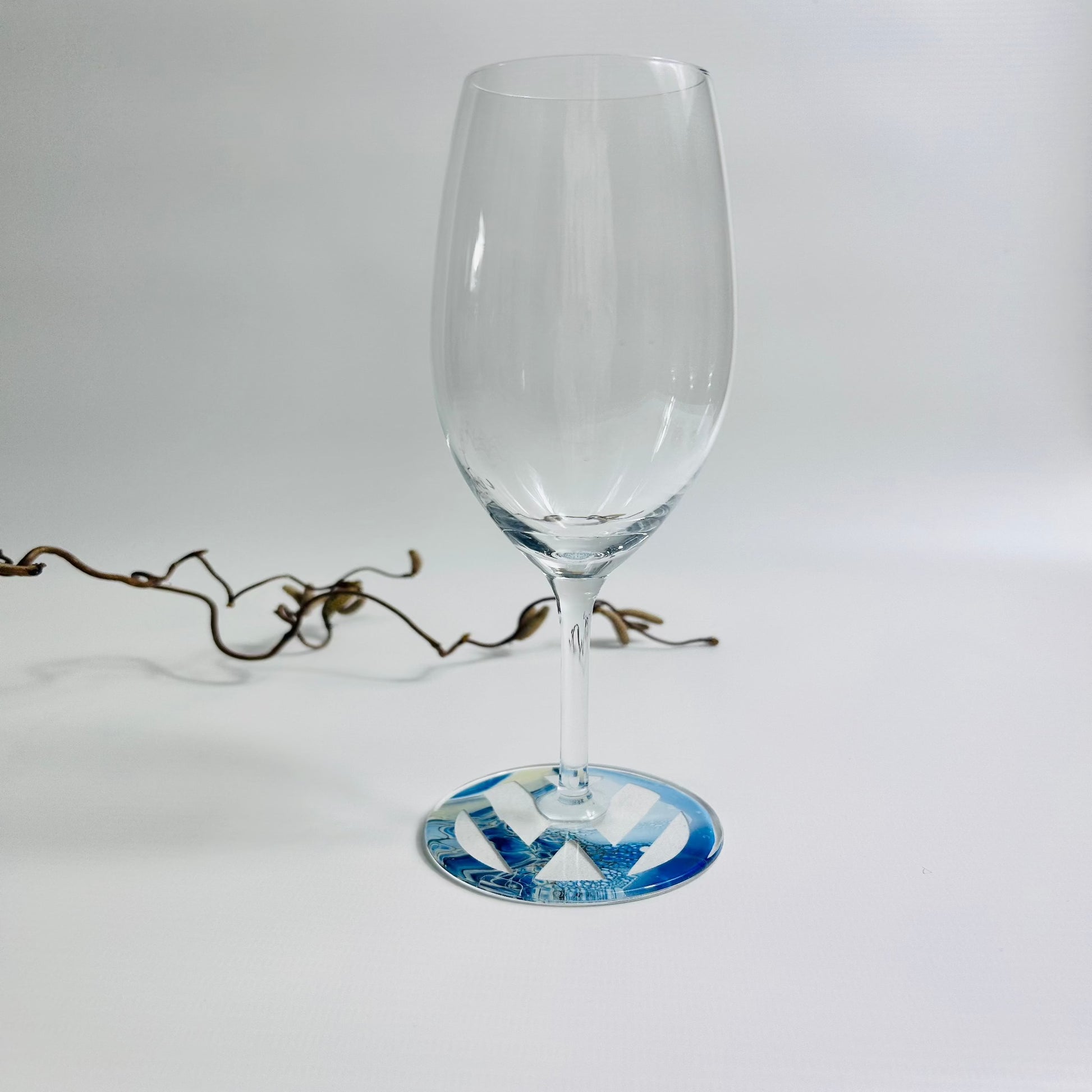 Prosecco glass with blue fluid art logo on the base, sealed in resin