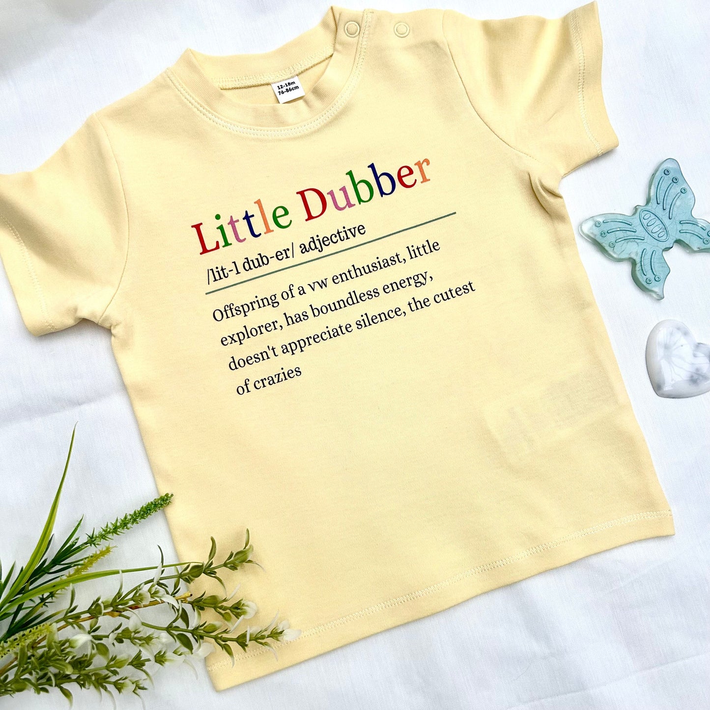 Soft yellow colour t shirt with logo saying little dubber offspring of a vw enthusitast, little explorer, has boundless energy, doesn't appreciate silence, the cutest of crazies